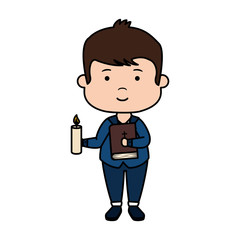 little boy with bible and candle first communion