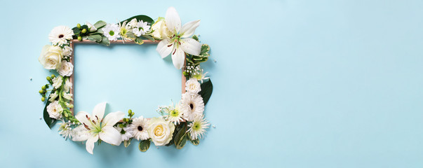 Frame of white flowers over blue background. Valentines day, Woman day concept. Spring or summer...
