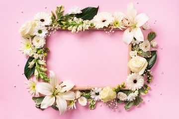Floral composition of white flowers, green leaves on grey paper background. Flat lay, top view. Spring and summer concept