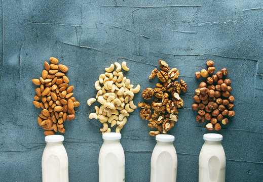 four kinds of vegetable milk in glass jars