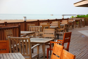 wood terrace with wooden table and desk on beach at sea view point.the restaurant on beach ,that there are wood components