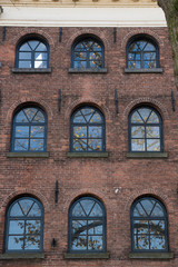 old brick storehouse with reflection in windows  in fortified city Gorinchem, The Netherlands