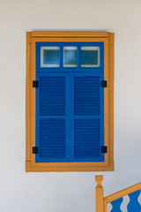 Window Blue clay wall painted white with its frame pintade of yellow