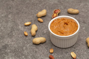 Creamy peanut butter and peanuts. Natural nutrition and organic food. Selective focus. 