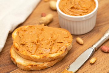 Peanut butter sandwiches or toasts on wooden background. Tasty Breakfast. Selective focus 