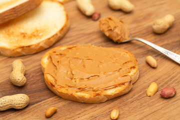 Peanut butter sandwiches or toasts on wooden background. Tasty Breakfast. Selective focus 