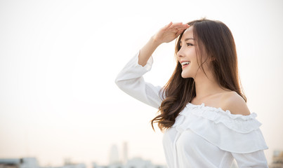 Portrait of young beautiful innocence asian woman in sky roof top. Smile face asian girl wear...