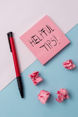 Writing note showing Helpful Tips. Business concept for advices given to be helpful knowledge in...