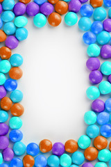 Frame of multi-colored candies close up. Rainbow colored dragee multicolored glaze on a white background