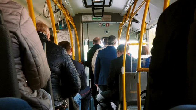 People in a public bus riding on street.