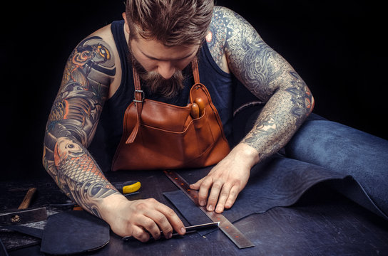 Leather Worker keen on one's business at his leather studio