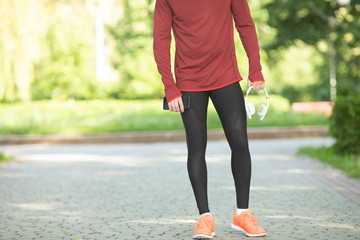 Male runner running on road training for fitness. Man doing jogging workout run outside in summer in nature