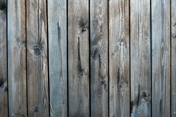 Wall, fence made of wooden boards with an interesting pattern and structure of wood.