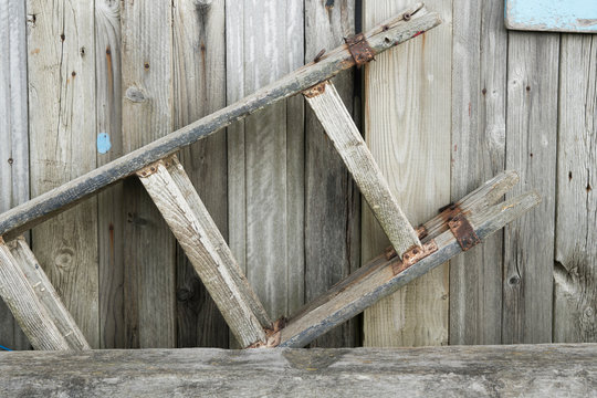 close up old wooden ladder,  stair, hanging on shelf background