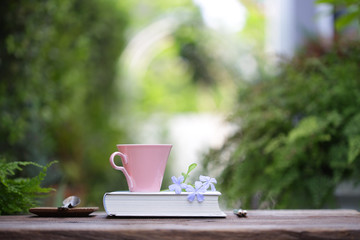 pink coffee cup and book with flowers