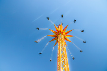 Kouvola, Finland - 18 May 2019: Ride Star Flyer in motion on sky background in amusement park...