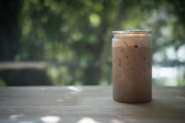 Iced mocha in clear plastic bottles on wood table in coffee shop