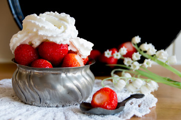 fresh strawberries with whipped cream in metal bowl
