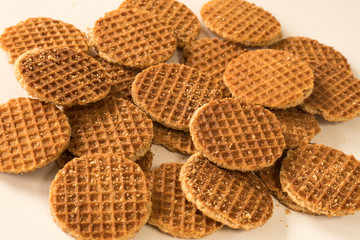 typical Dutch food cookie stroopwafel, syrup waffle, against white background
