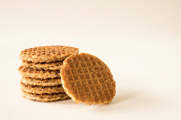 typical Dutch food cookie stroopwafel, syrup waffle, against white background