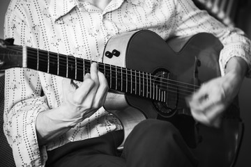 An acoustic guitar player, close-up
