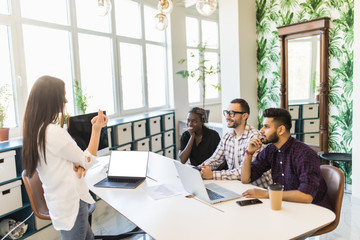 CEO boss female speaker manager presenting a lecture in the boardroom office workplace to colleagues.