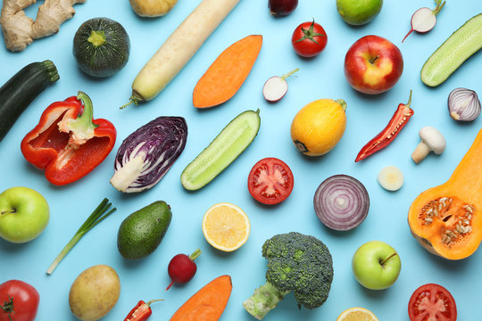 Flat lay composition with fresh ripe vegetables and fruits on color background