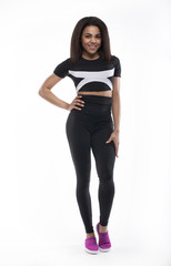 Full length portrait of a young fitness woman in sportswear posing a isolated over white background 