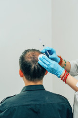 Mesotherapy of hair and head. Injections in the head. Fighting hair loss in men. Men's bald spot in...