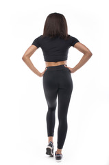 Fototapeta premium back view of young black woman in sportswear on white background. 