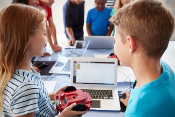 Obraz na płótnie Canvas Group Of Students In After School Computer Coding Class Learning To Program Robot Vehicle
