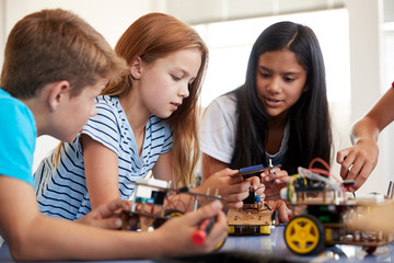 Students In After School Computer Coding Class Building And Learning To Program Robot Vehicle
