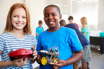 Portrait Of Male And Female Students Building Robot Vehicle In After School Computer Coding Class - obrazy, fototapety, plakaty