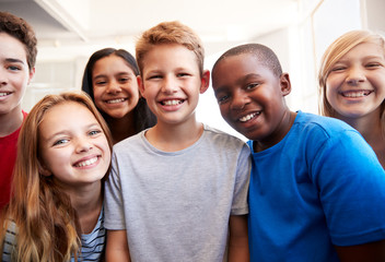 Portrait Of Smiling Male And Female Students In Grade School Classroom - Powered by Adobe