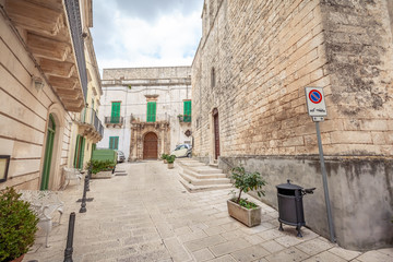 View of the old town of Martina Franca with a beautiful houses painted in white. - obrazy, fototapety, plakaty