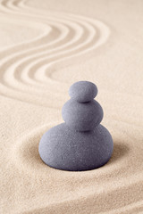 Fototapeta na wymiar Stone stack, Japanese zen sand garden with pile of rocks. Concept for balance and purity.