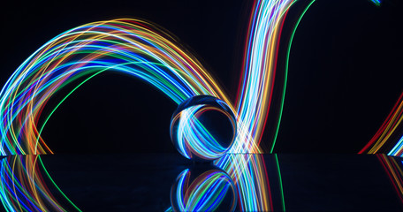 Light painting with crystal ball using led Christmas colorful lights and light reflection on glass with selective focus