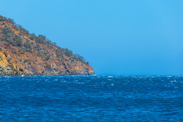 Fototapeta na wymiar closeup cliff among the emerald sea at the storm
