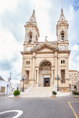 Fototapeta na wymiar Alberobello, Puglia, Italy. View of the Famous village with Cathedral of Saints Cosmas and Damian.