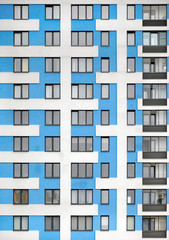 The facade of a blue modern high-rise building. Windows and balconies.