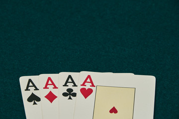 on the green table, stands out a set of four aces, at the bottom of the image leaving large space for inscriptions above