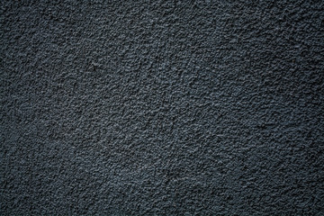 Gray monophonic background or texture with roughness. Blue shade. Plaster on a wall.