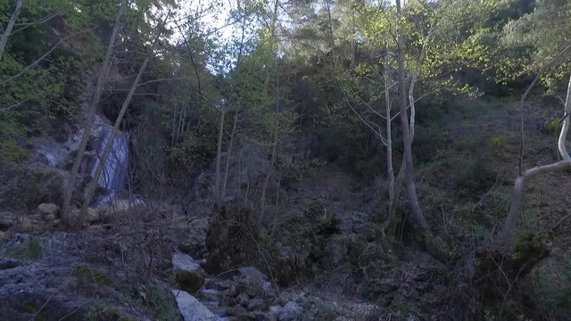 Tilt down on a waterfall feeding a stream at Lassa, Mount Lebanon