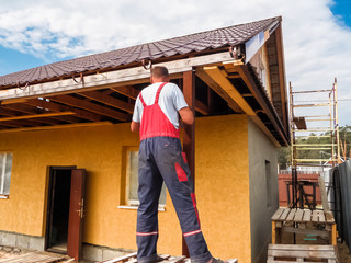 Fototapeta premium The builder on the roof