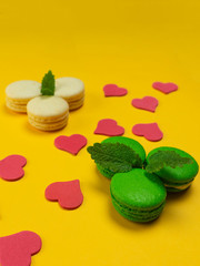 Colorful macaroons on a yellow background. Concept for the holiday. Copy space