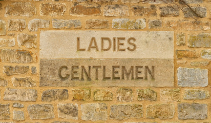 Ladies and Gentlemen sign carved in stone, The Cotswolds United Kingdom