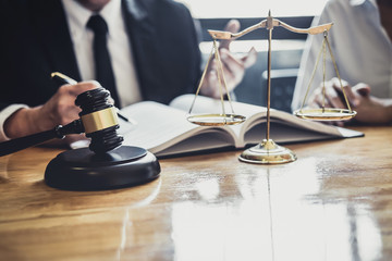 Male lawyer or Counselor working in courtroom have meeting with client are consultation with contract papers of real estate, Law and Legal services concept