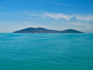 Naklejka na ściany i meble View of island sea and sky with clouds from cruise ship, Prince islands, Turkey.