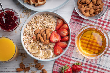 Breakfast. Sweet oatmeal, waffle with berry. Delicious granola. Dessert. Muesli. Morning meal set on white background top view