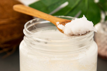 Close up Coconut butter bottle, for beauty care or healthy vegan food. Grey background.